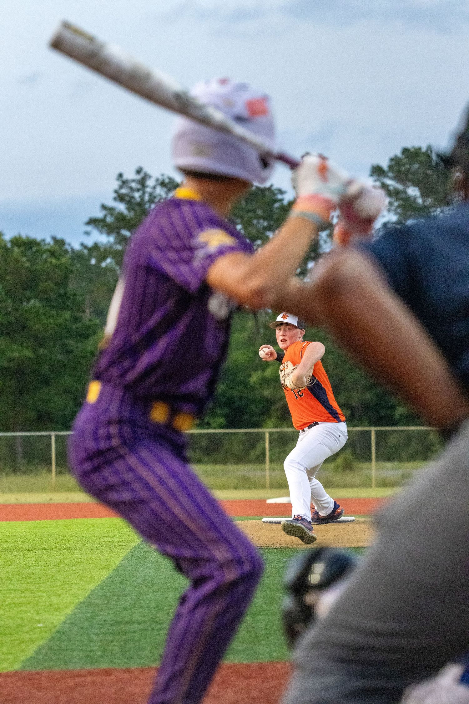 Baseball game sequence showing a player in orange uniform on the field against players in purple.