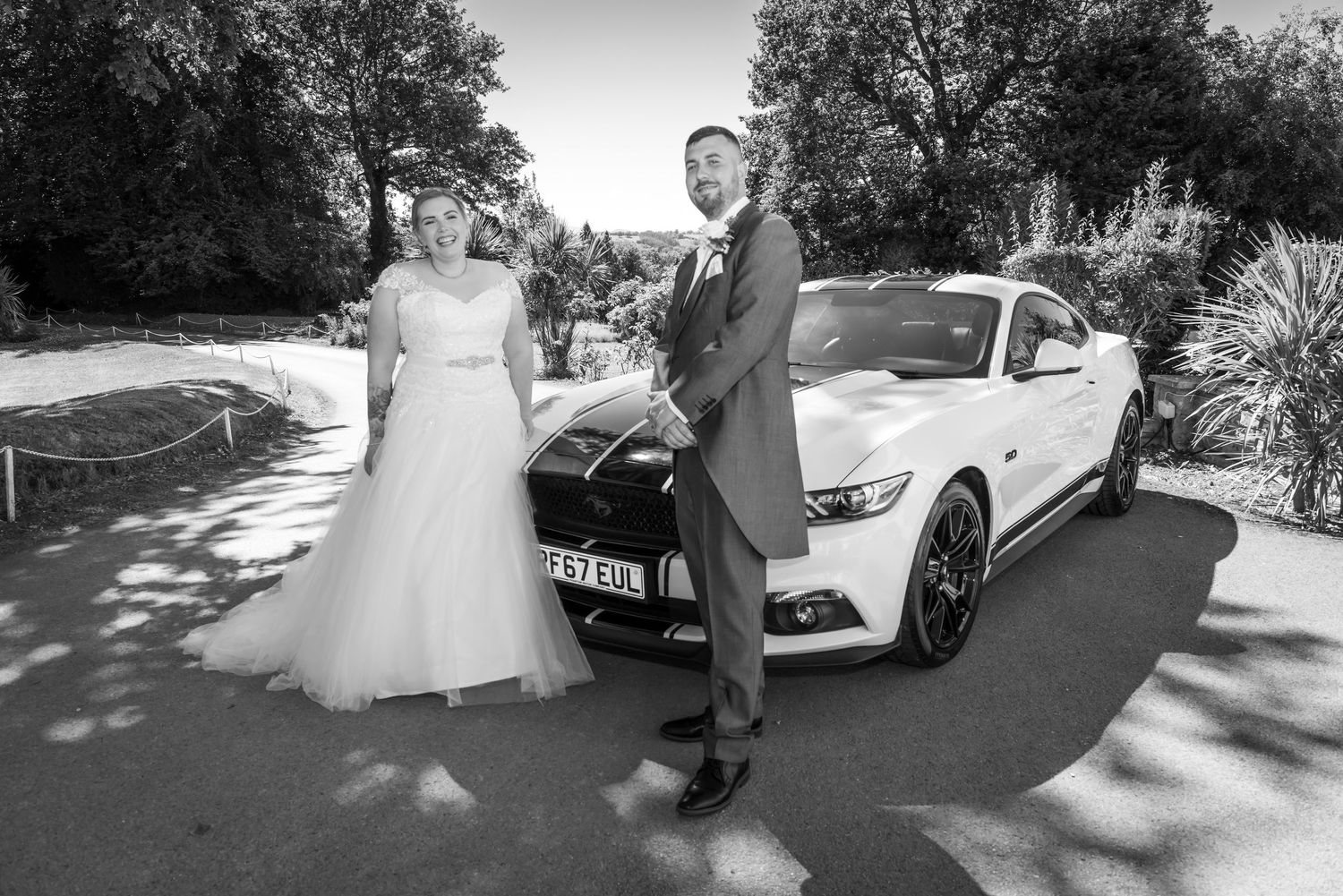 happy married couple at Highfield Hall in front of a Ford Mustang by Cheshire wedding photographer Michael Pardoe