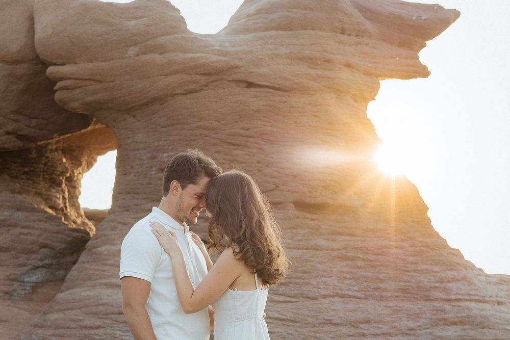 romantic couples engagement session on rocky cliffs Alma NB destination photography, tourism New Brunswick, travel vacation photograph