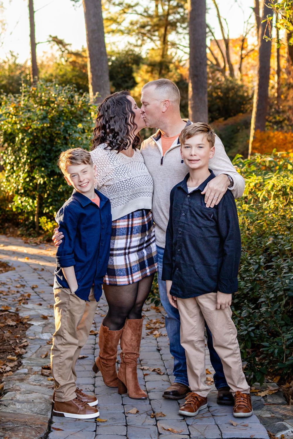 a family standing on a path in a garden