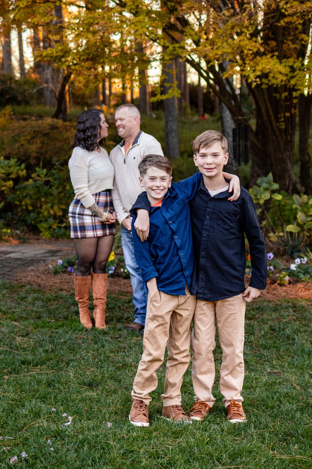 two brothers standing in front of their parents