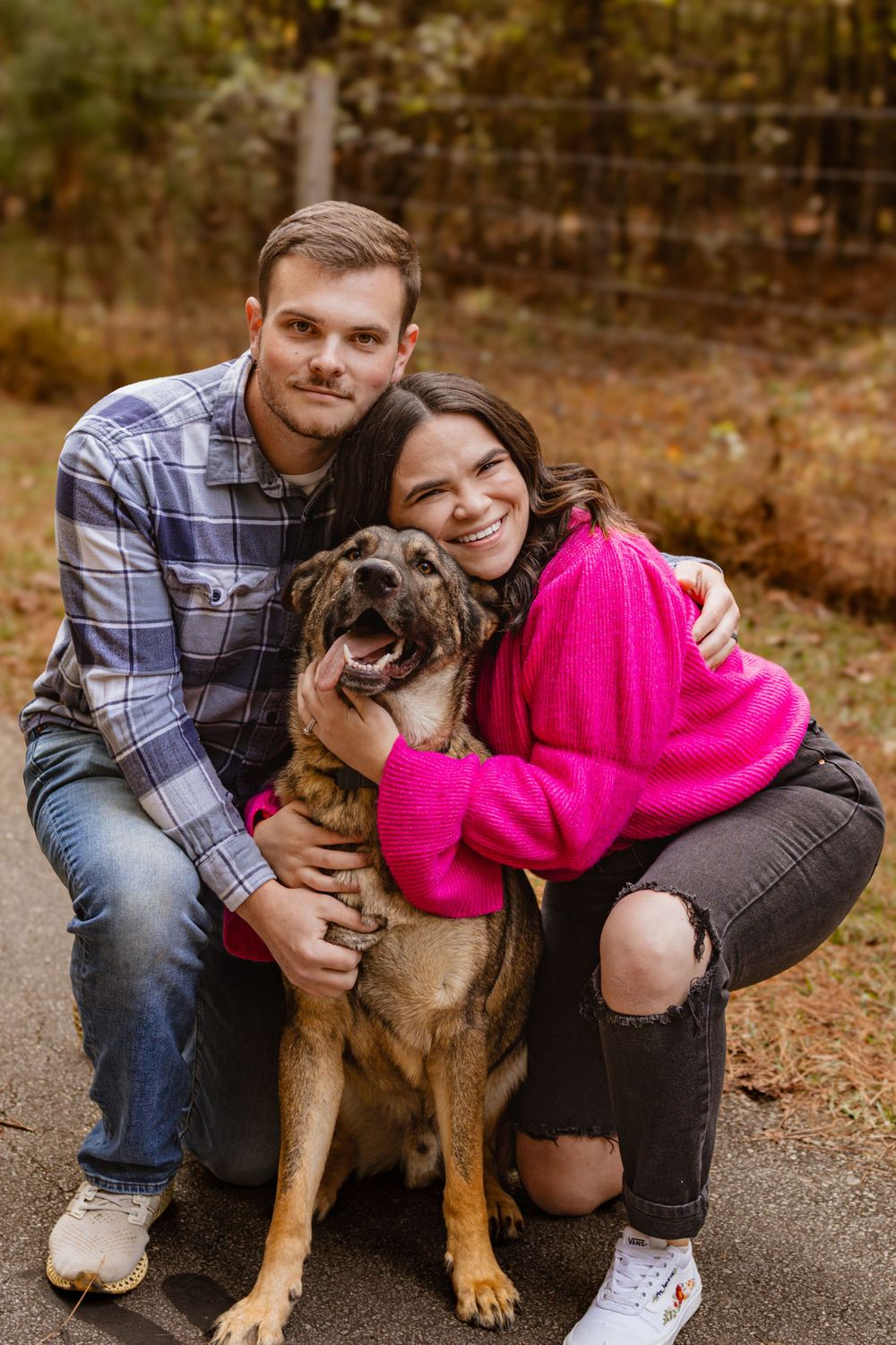 a man and women hugging a dog