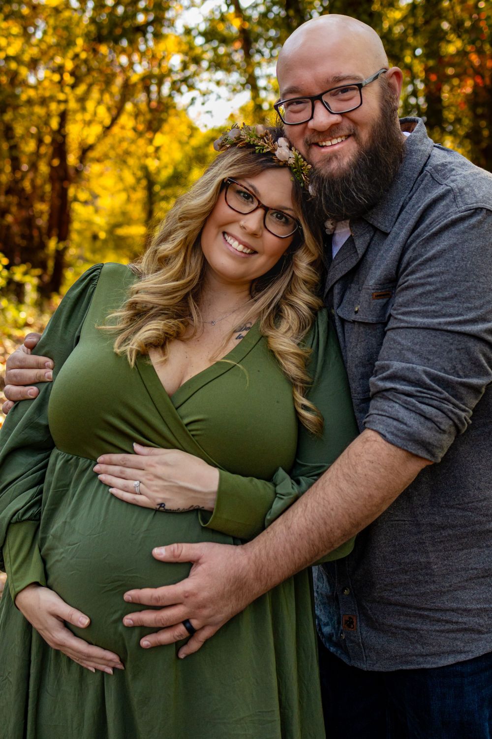 a close up portrait of a couple holding her pregnancy belly