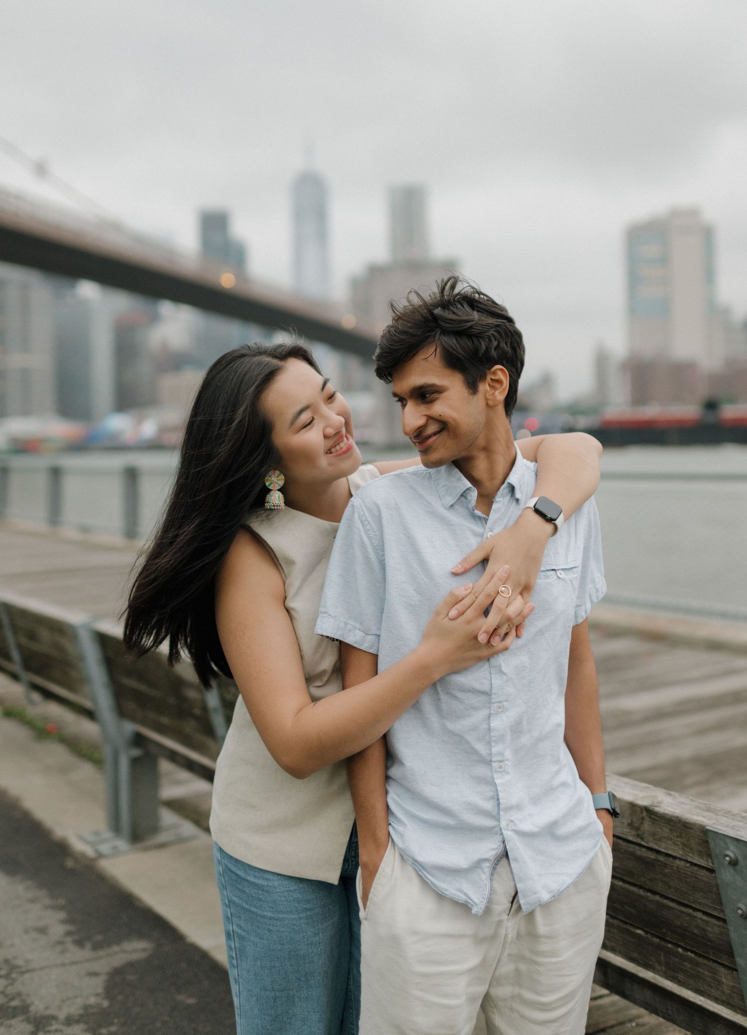 A romantic sequence of candid moments against an urban skyline backdrop.