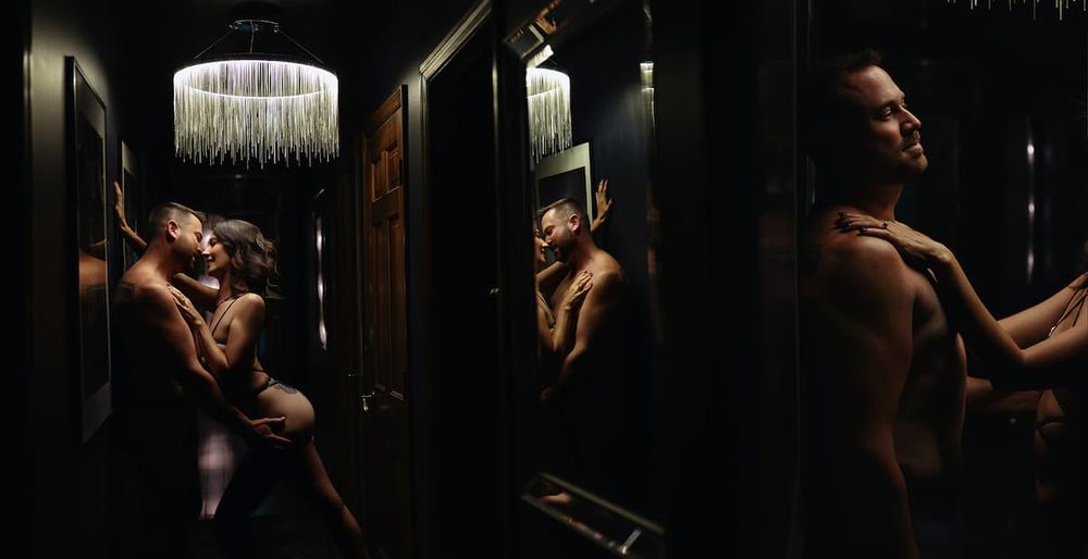 Dramatic boudoir photos showing silhouettes in moody lighting with a crystal chandelier overhead.