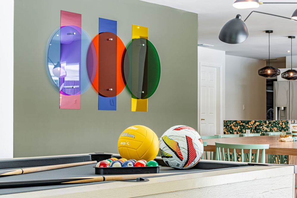 Modern interior design featuring colorful circular wall art installations in a minimalist space.