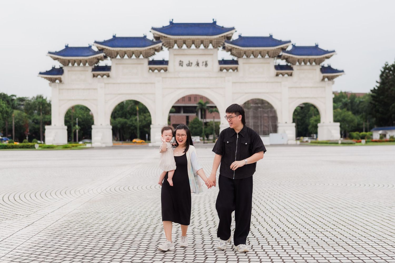 Two people stand in front of the Liberty Gate entrance at Chiang Kai-shek Memorial Hall in Taipei, Taiwan.