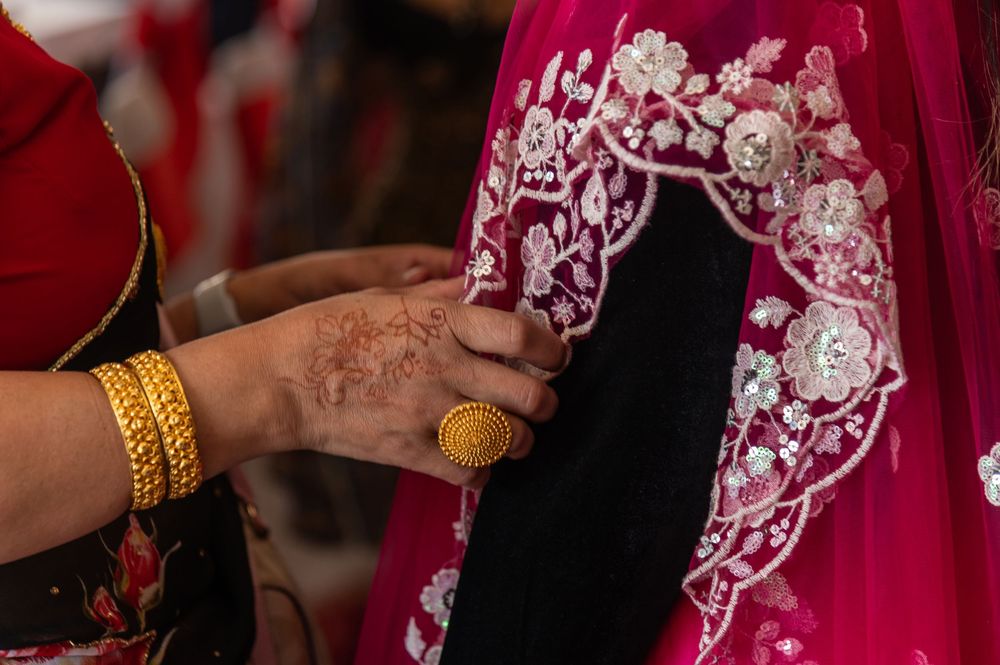 Close-up of traditional South Asian wedding jewelry and accessories in red and gold.