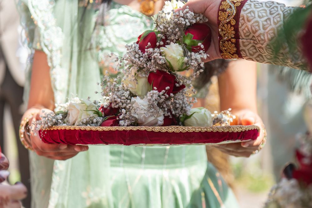 Wedding ceremony details showing floral arrangements and traditional Indian decorative elements.