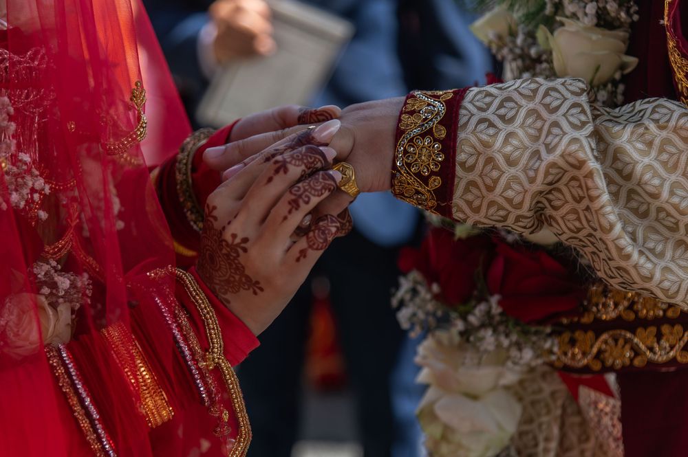 Intricate henna designs and jewelry details during an Indian wedding ceremony.
