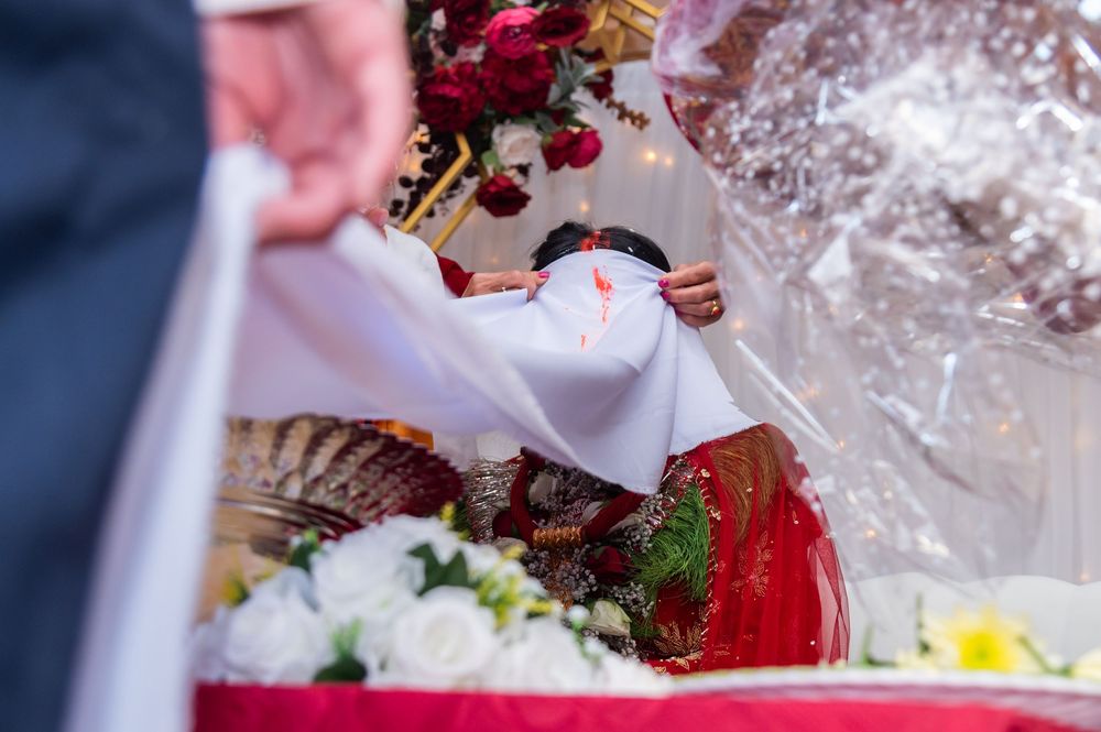 Close-up details of wedding decorations and ceremonial items in vibrant red and white colors.