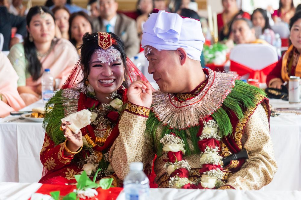 Wedding guests enjoying the celebration while seated at decorated tables.