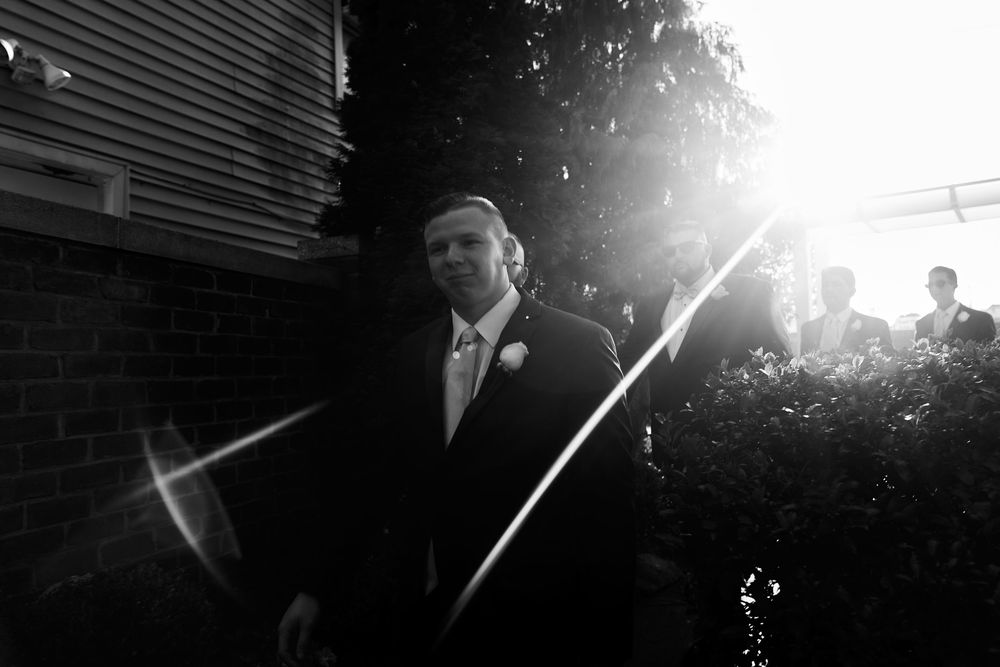 Artistic black and white photo with dramatic sun flare and shadows.