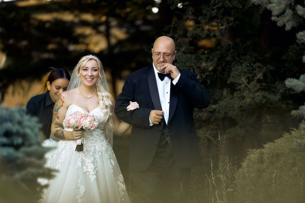 Wedding ceremony moment captured in natural light among garden landscaping.