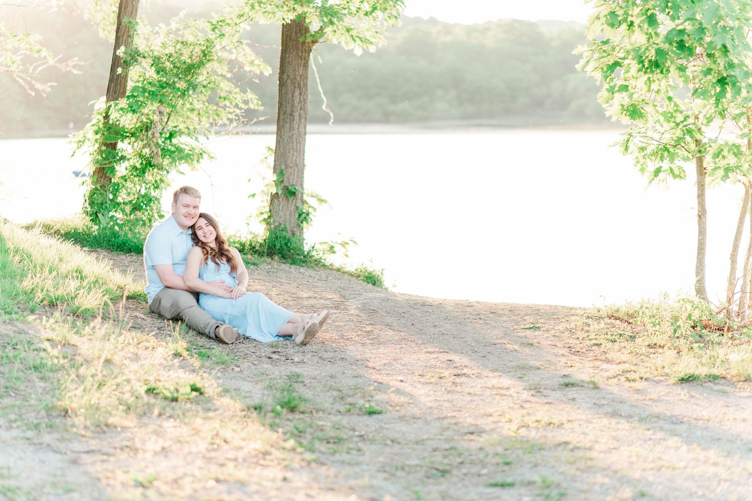Engagement session at Quemahoning Reservoir in Johnstown Pennsylvania, laying together by the water