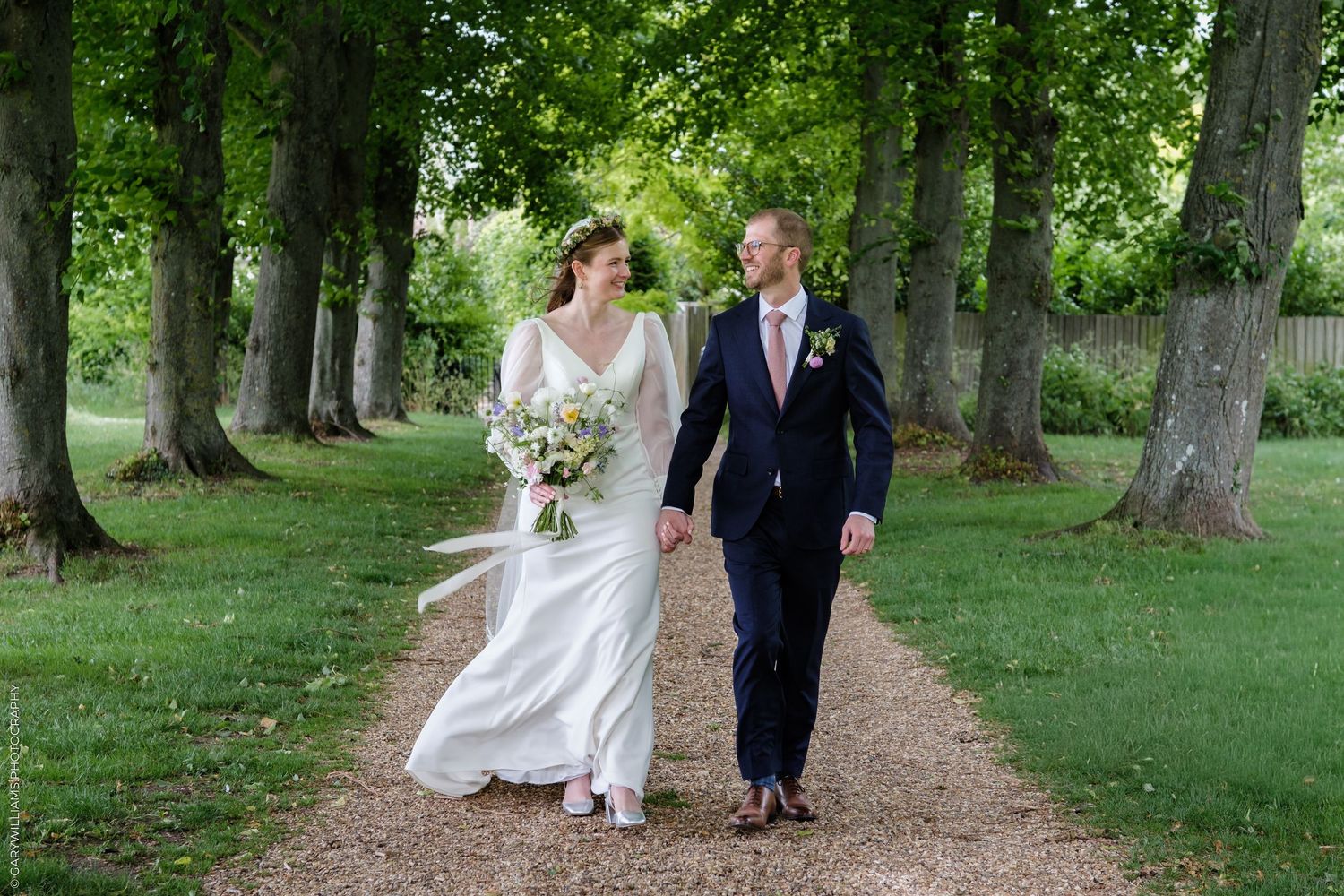 A series of black and white wedding photos showing a bride in a ballgown and guests at an elegant indoor reception.