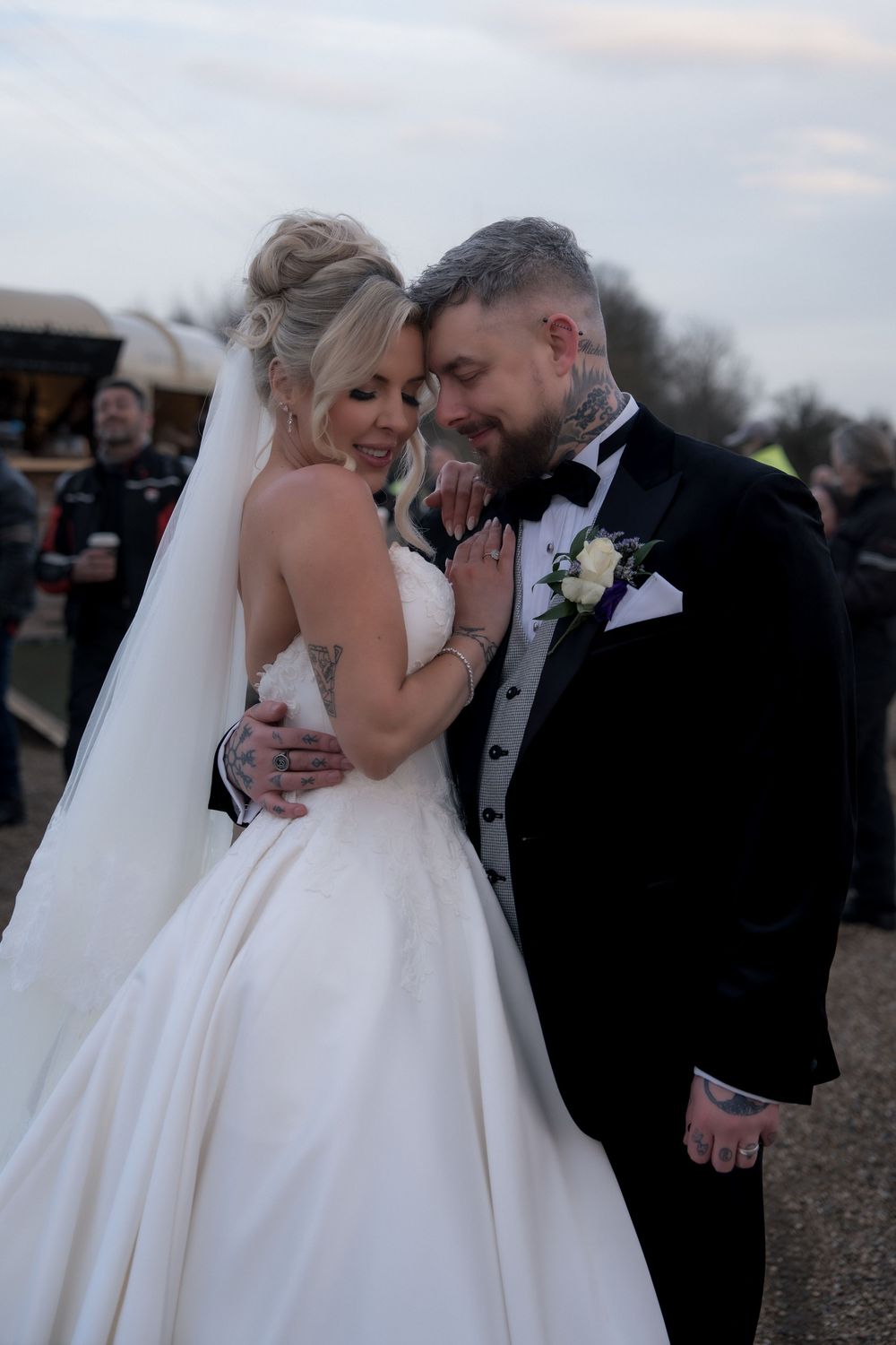 A couple shares an intimate moment during their outdoor winter wedding celebration.