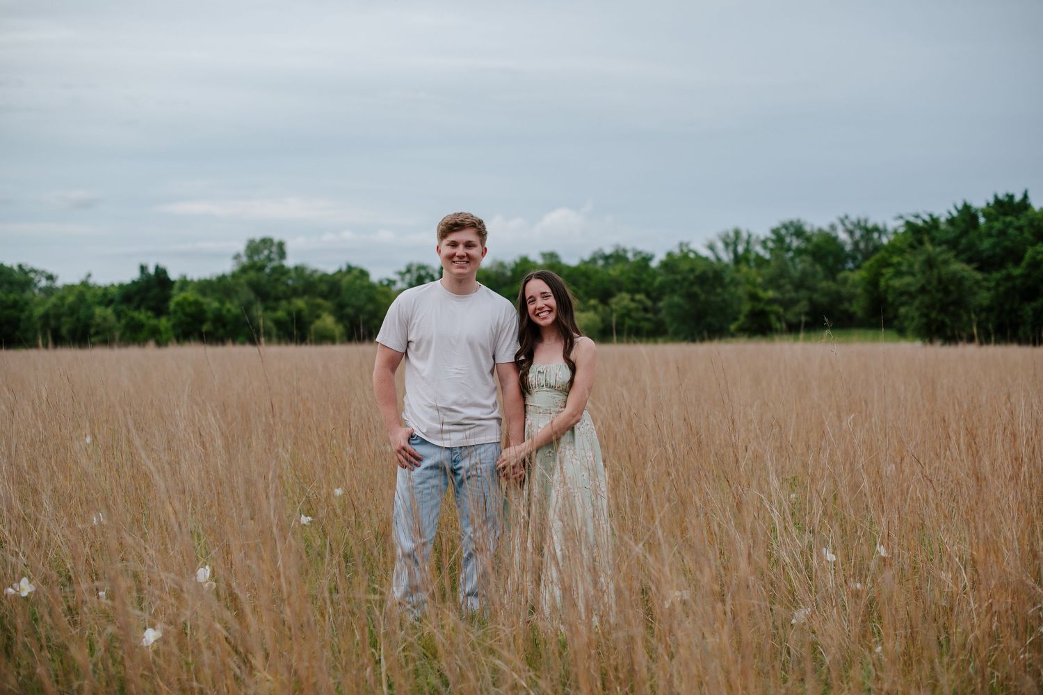 Wichita KS outdoor engagement photos in nature location Andover, couple photos in field with flowers, small elopement wedding photographer