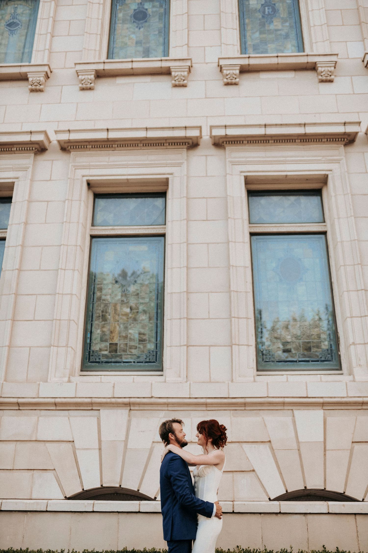 Engaged couple sharing a kiss in Downtown Dallas Historic District