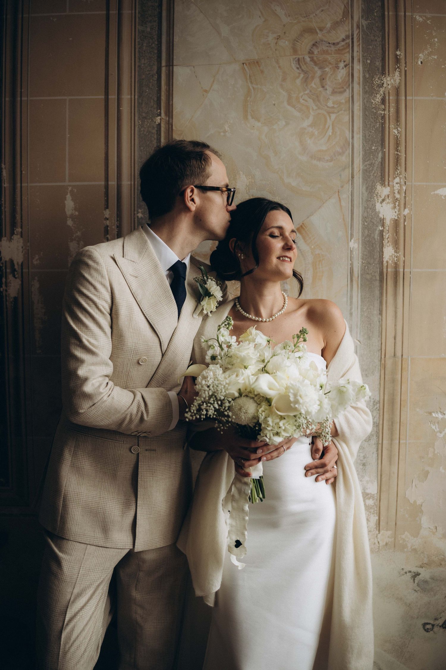 A tender autumn embrace captured during a wedding photoshoot with fall foliage.