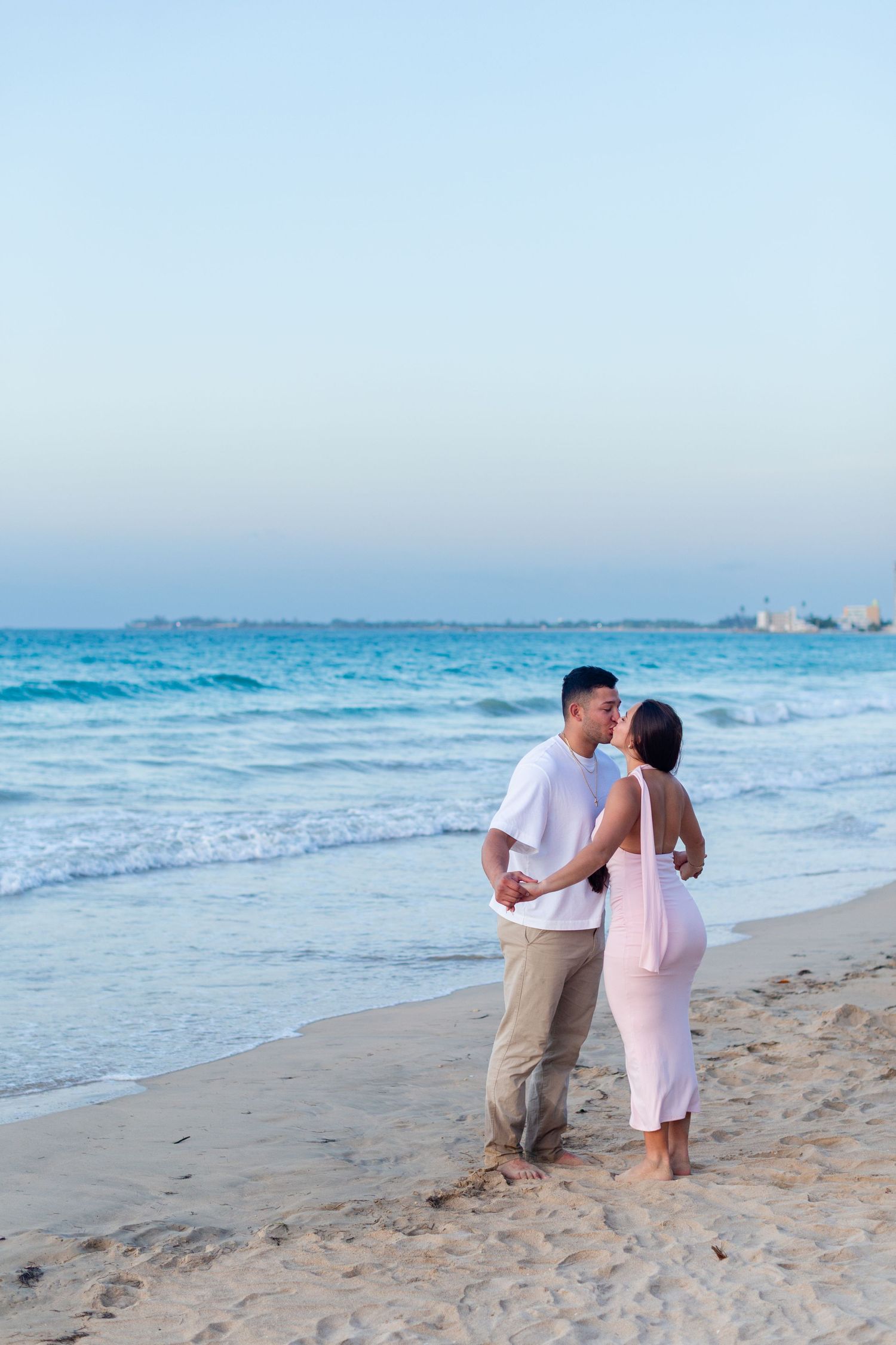 Couples portrait kissing on the beach in Isla Verde, Carolina, Puerto Rico.