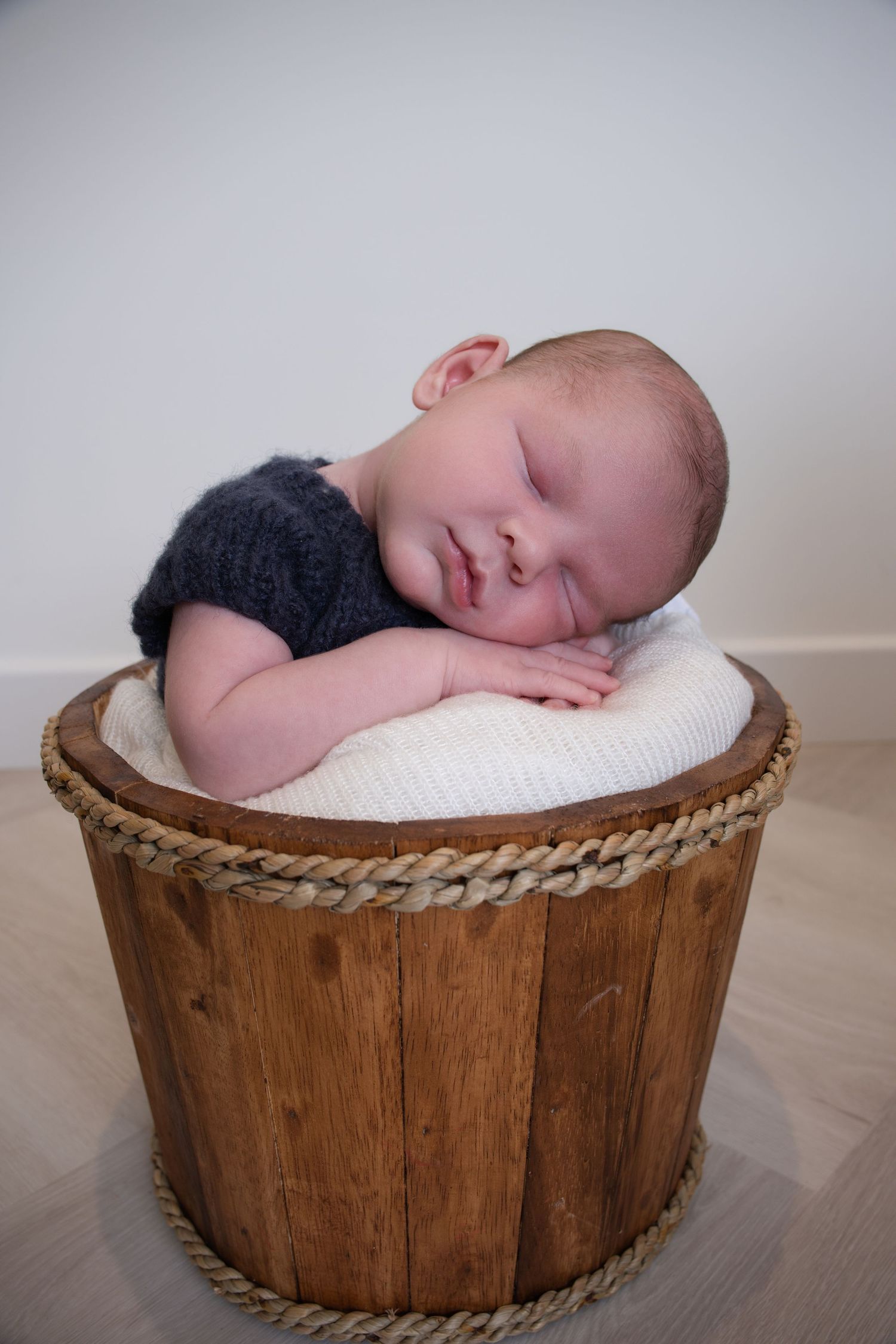 Newborn boy side pose on beanbag with blue wrap — newborn photography near Devizes