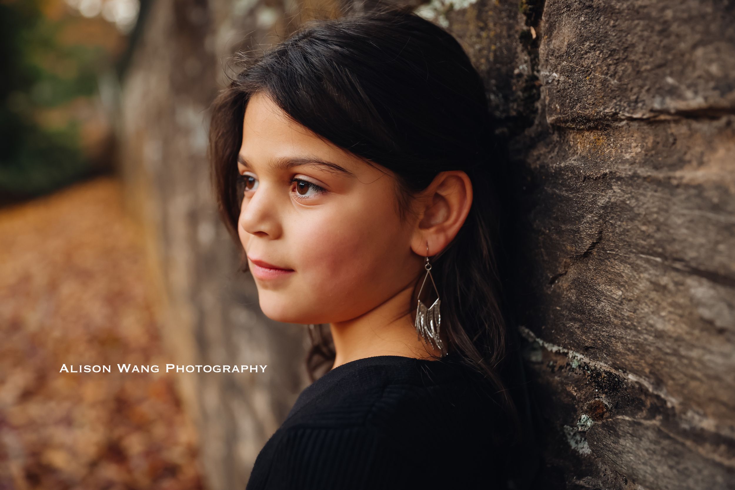 Portrait photography showing artistic close-up shots against stone wall backdrop in warm autumn lighting.