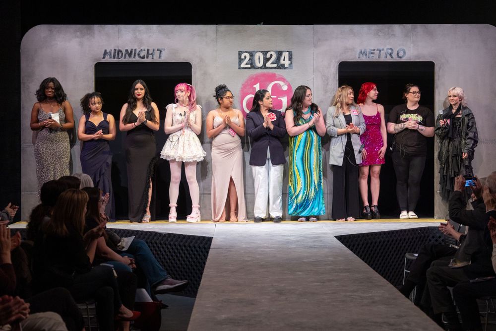 Group of diverse women on a runway at a 2024 Midnight Metro fashion show event.