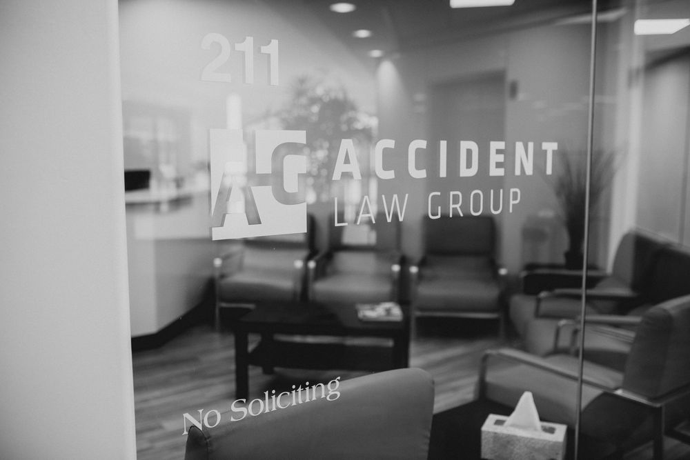 Black and white photo of AC Accident Law Group office entrance at suite 211 with No Soliciting sign on glass door.