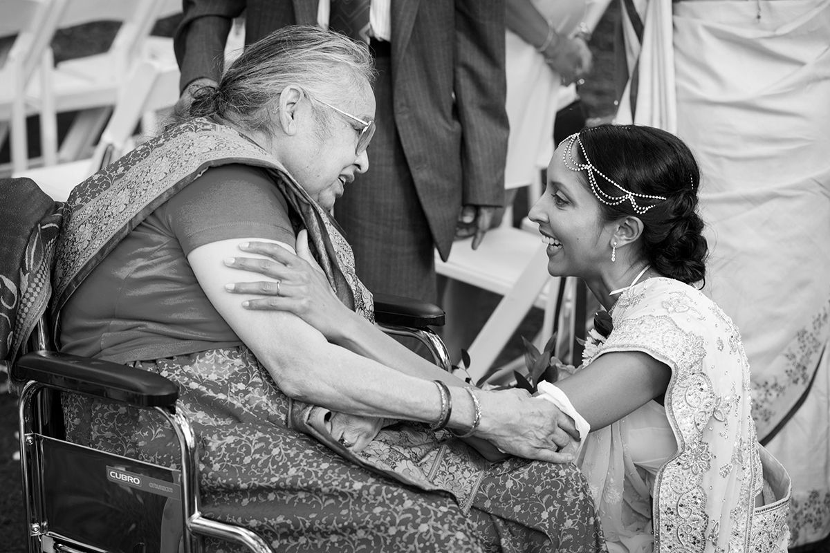 A candid photo of an Indian bride and her grandmother embracing