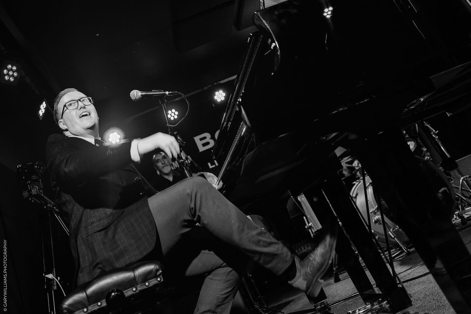 Black and white photo of Tom Seals on stage at Boisdale