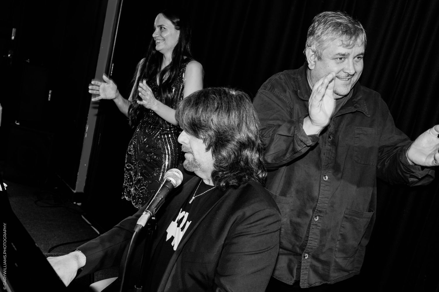 Black and white photo of Ben Waters on stage at Boisdale