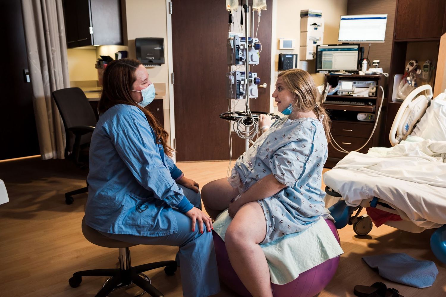 Healthcare professionals provide care and support in a hospital room setting.