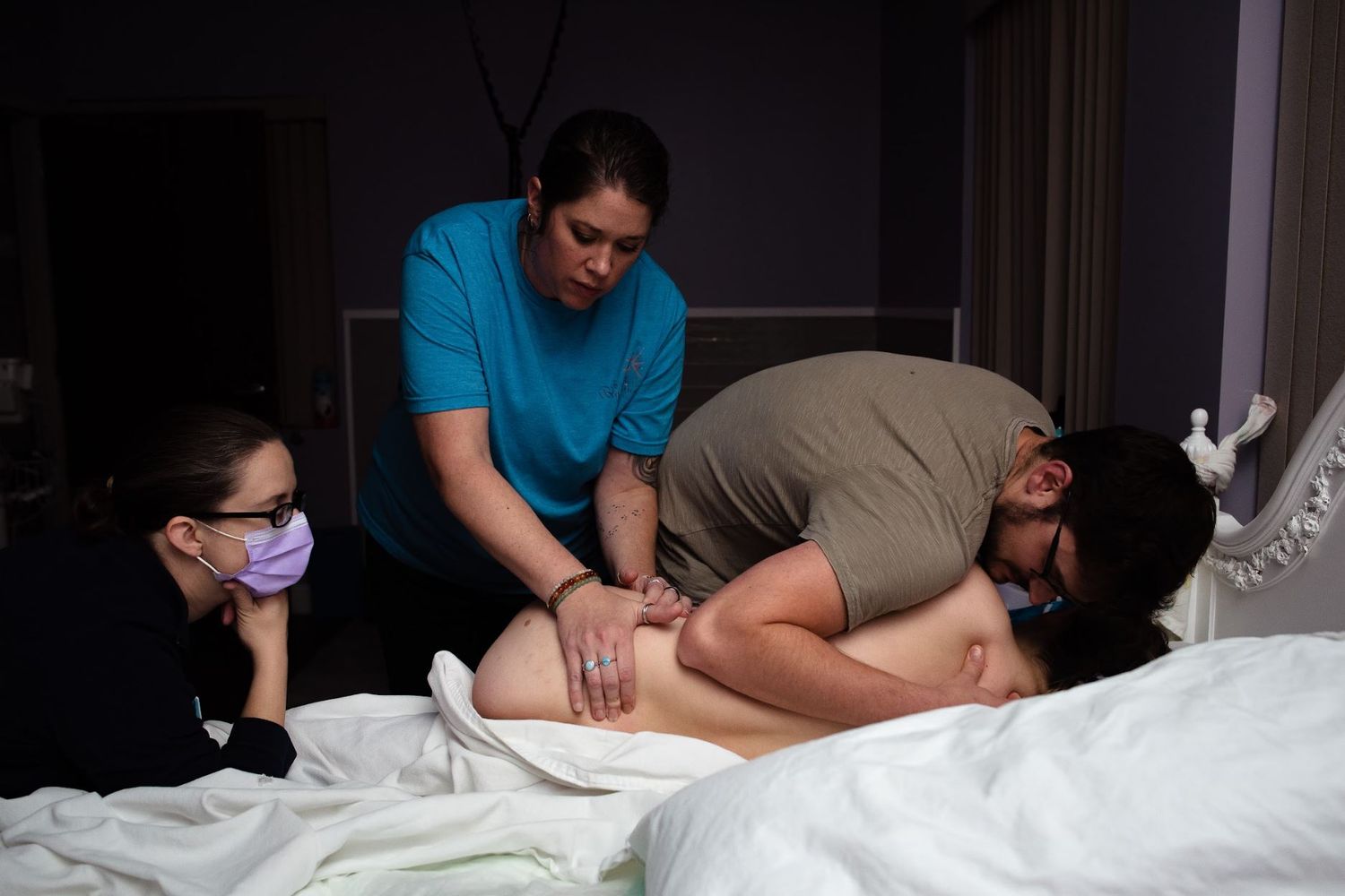 Midwife and doula providing care and support during labor