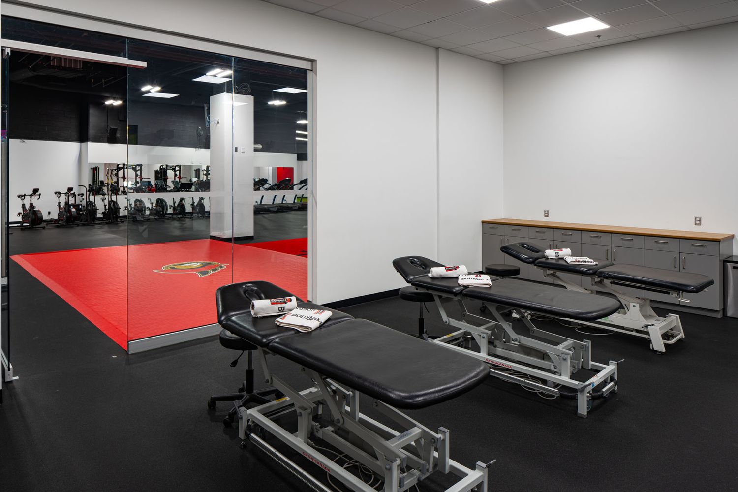 Professional interior shot of a modern sports medical clinic, highlighting clean lines, sterile surfaces, and functional spatial design