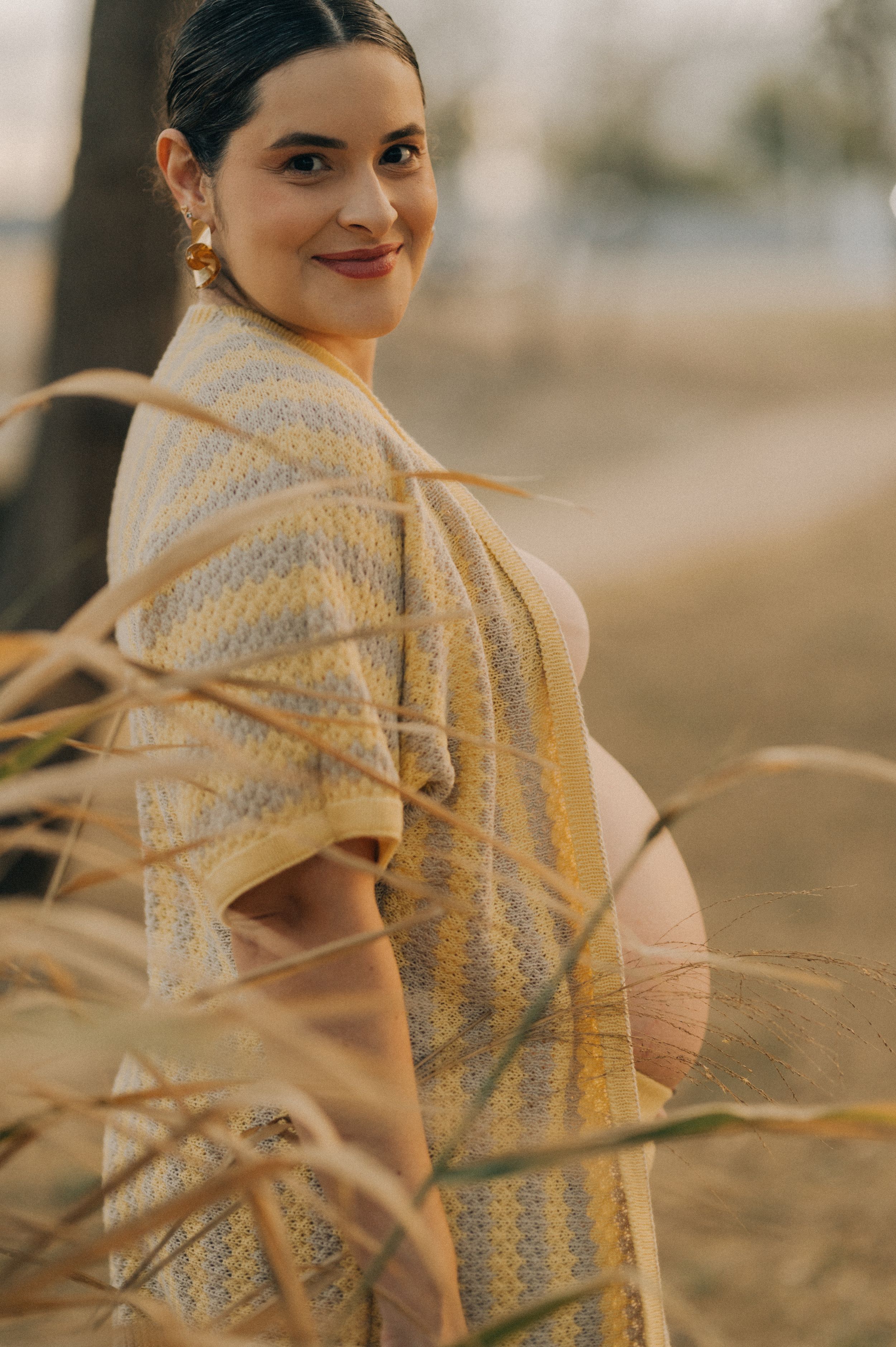 A person in a cream-colored knit shawl poses outdoors in warm lighting across multiple sequential photos.