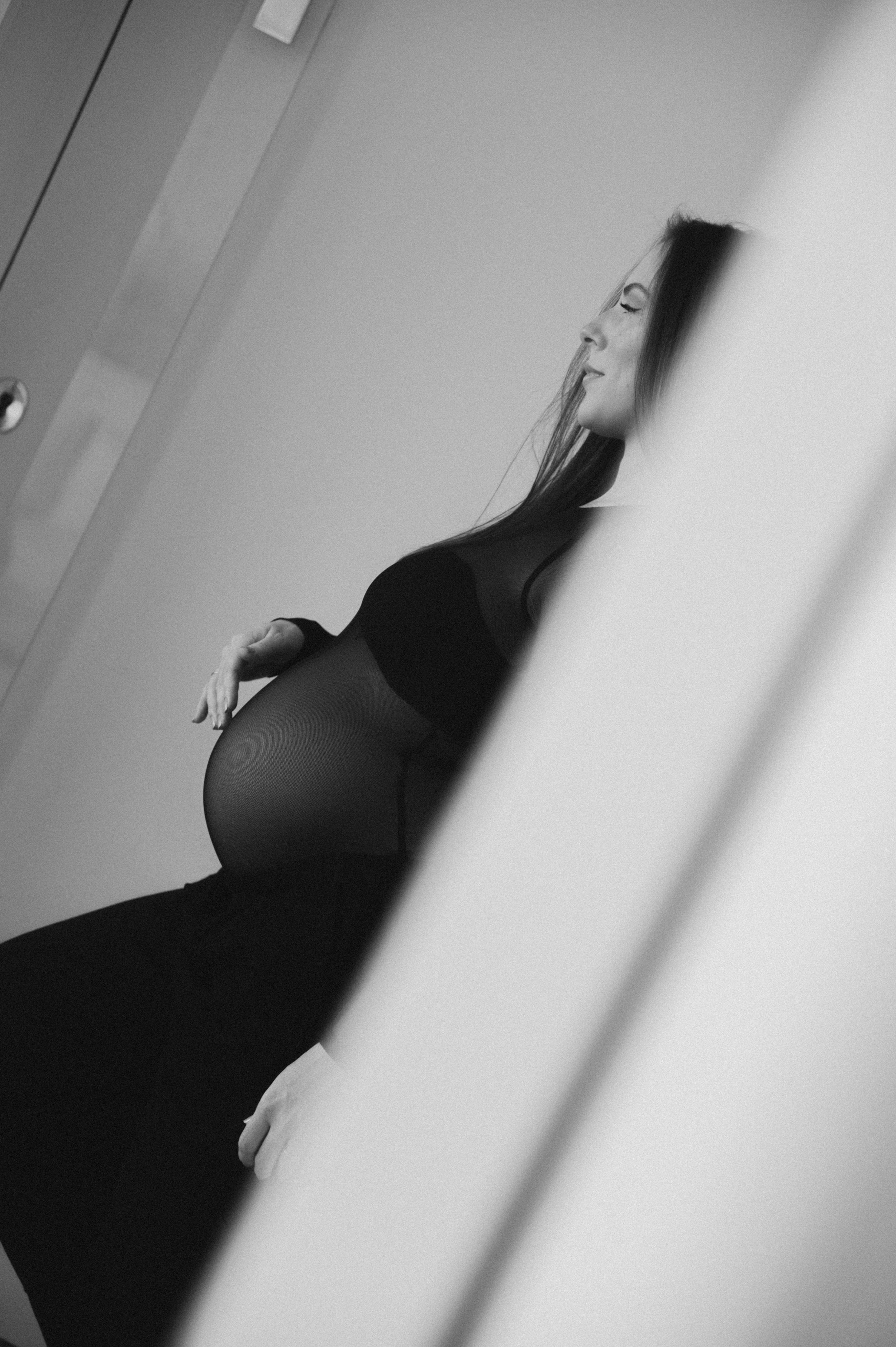 A series of minimalist black and white photographs showing abstract silhouettes and shadows against a light background.