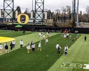 Oregon Ducks women's lacrosse team warms up on the field before a game at their home stadium.