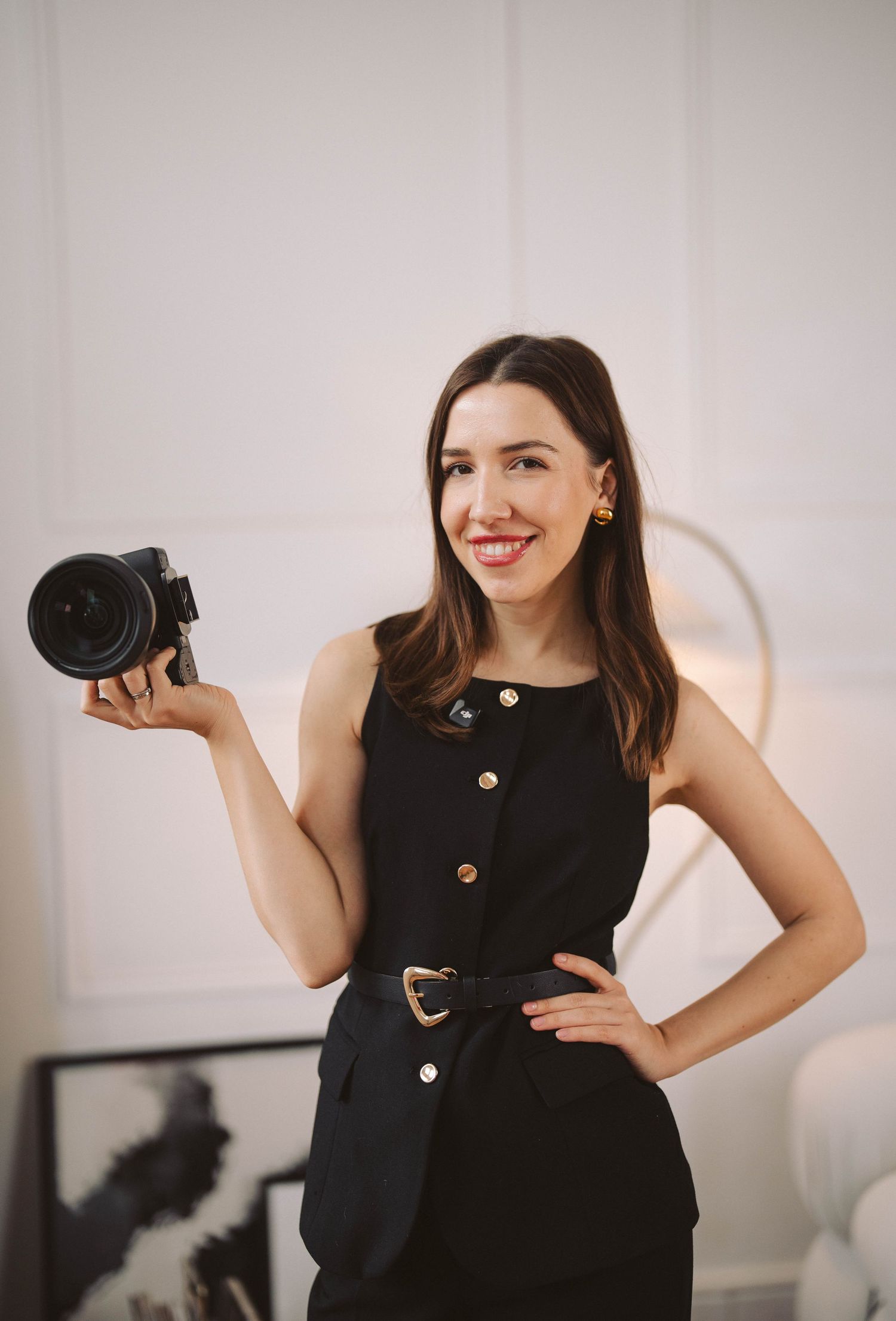 Fashion portrait series of a woman in white shirt and dark pants posing in a minimalist studio setting.