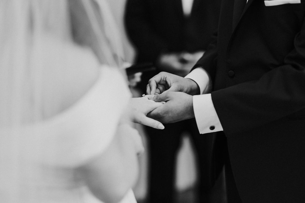 groom placing ring on hand