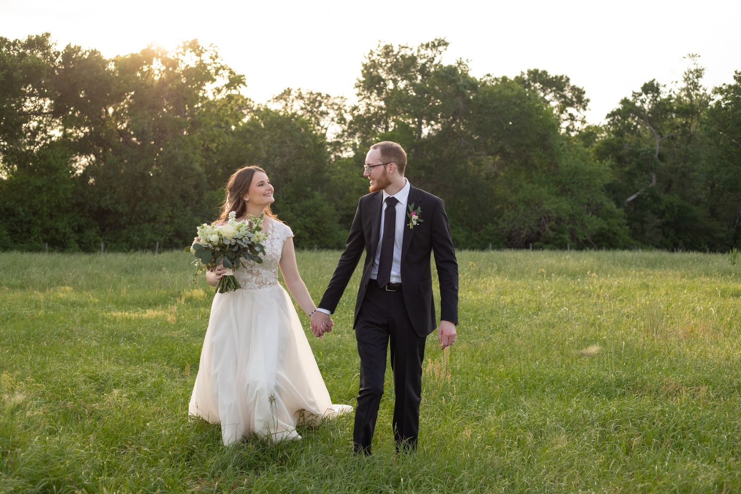 Bride and groom walking holding hands