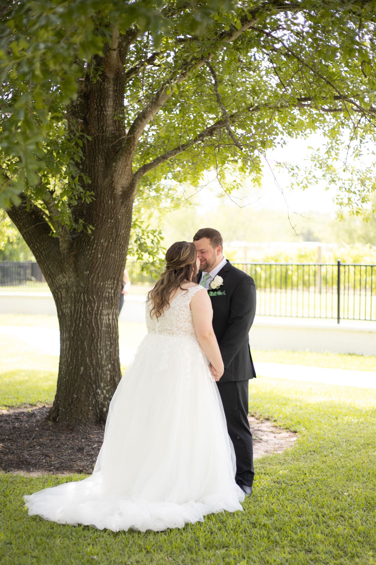Bride and groom holding hands and smiling at each other