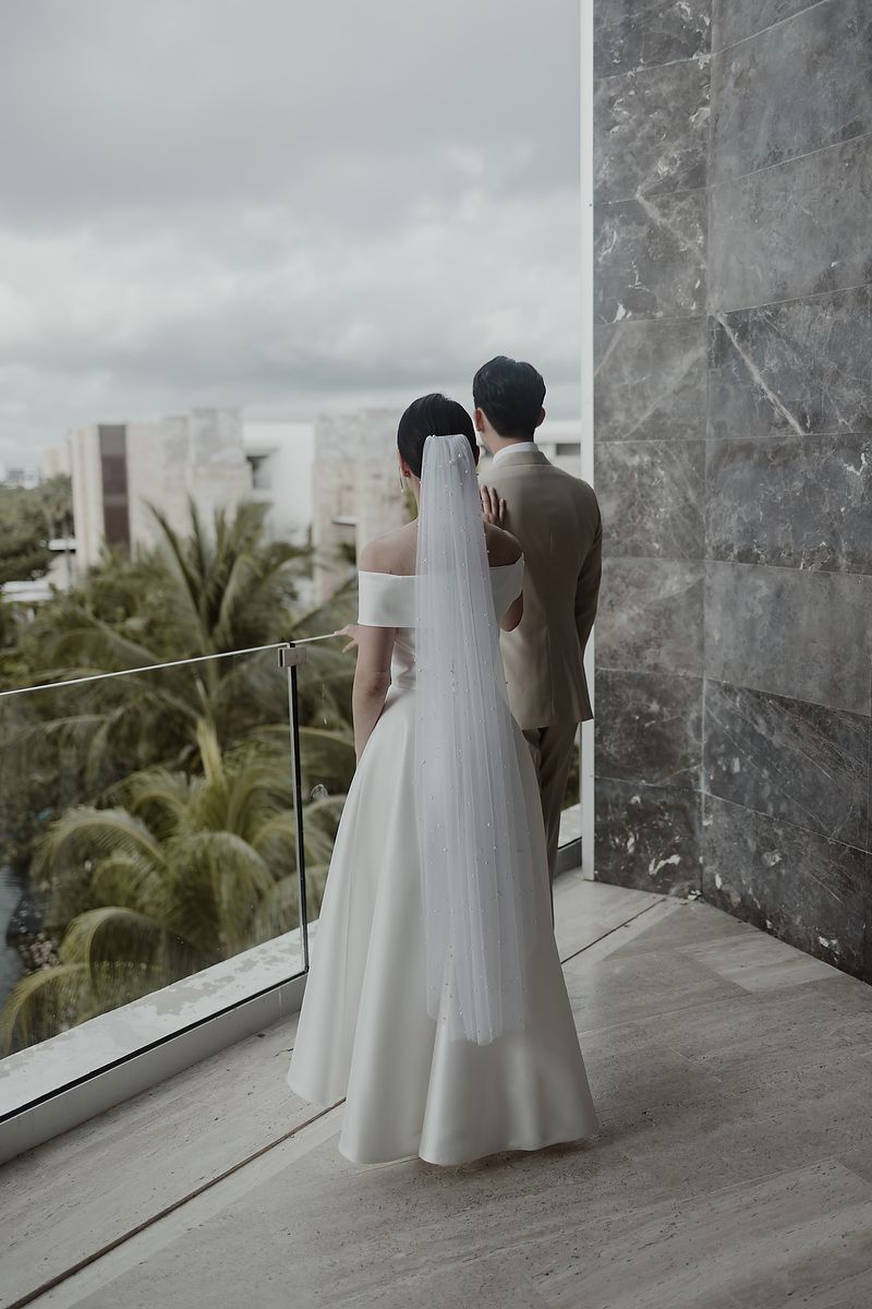 Series of wedding photos showing couple in elegant attire overlooking tropical palm trees from marble balcony.