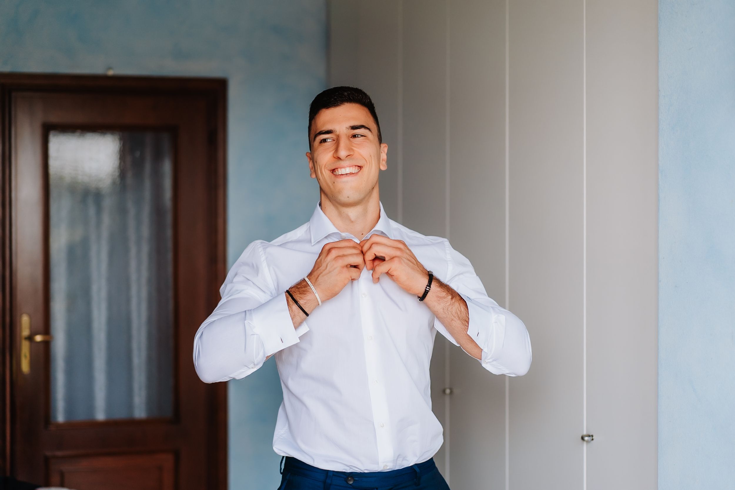 A collage of four similar photos showing someone in a white button-down shirt against a light colored wall.