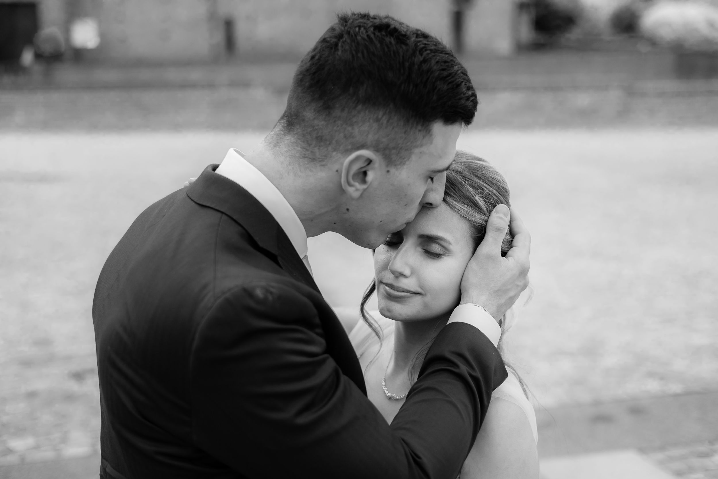 Black and white wedding photo sequence showing intimate romantic moments between a bride and groom outdoors.