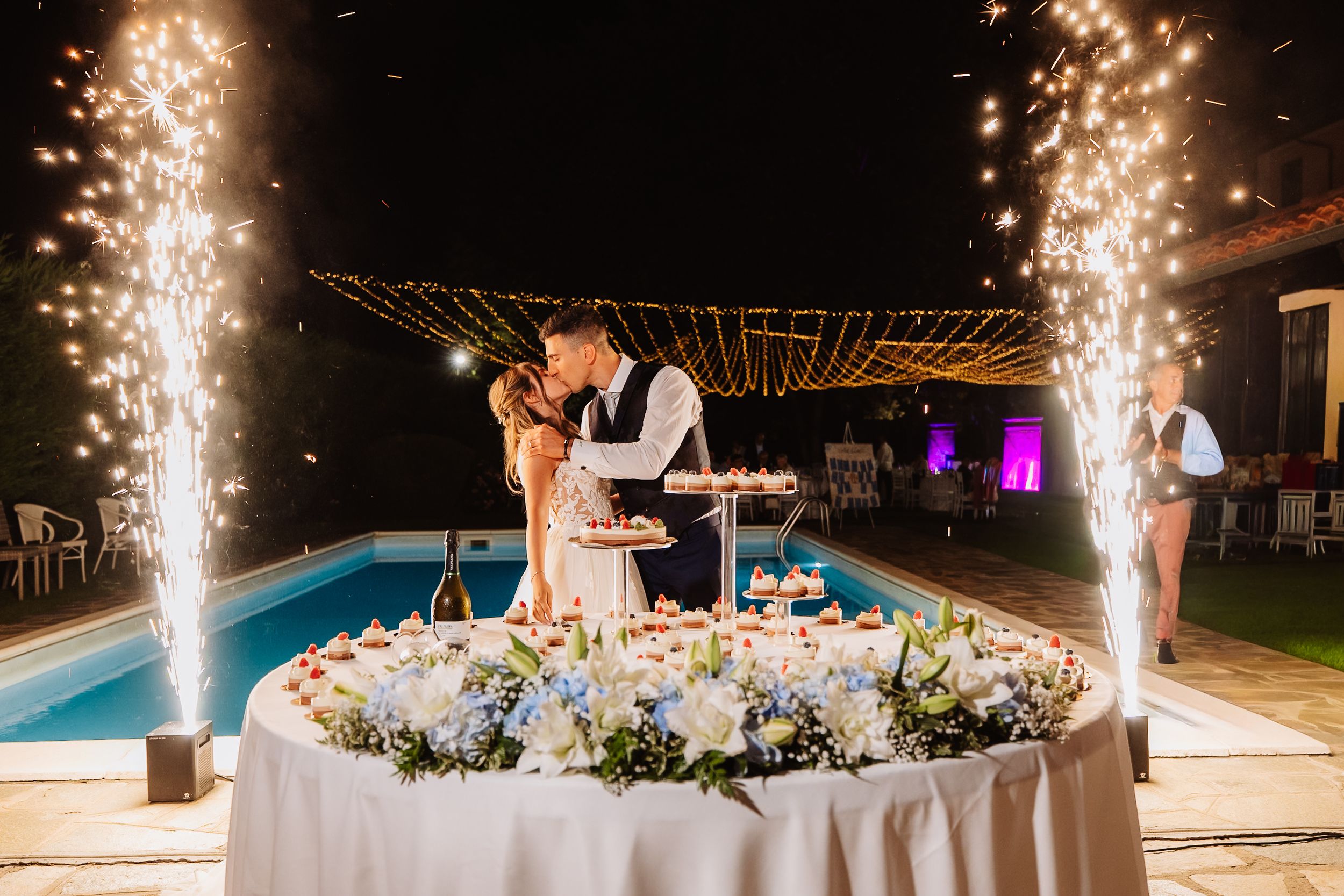 Wedding sparklers created a magical path around the swimming pool during an evening reception celebration.