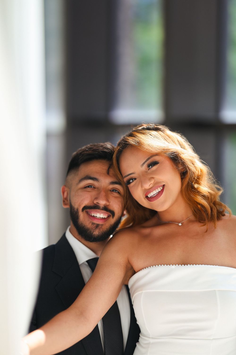 A romantic wedding photoshoot showing a close-up portrait of a couple in formal attire.