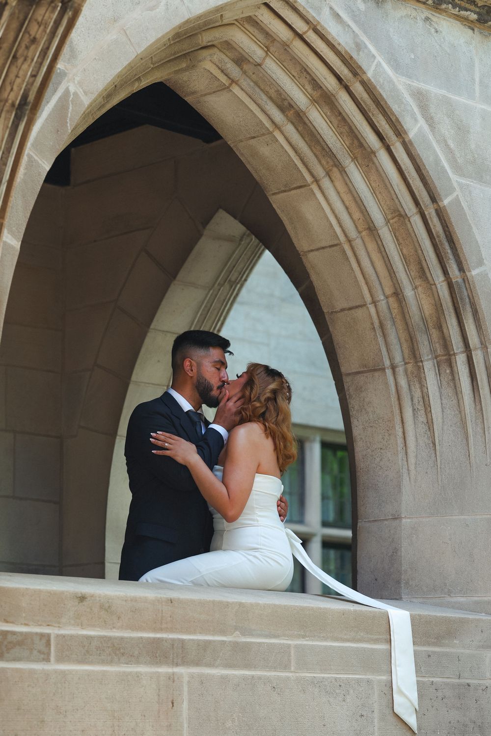 Wedding photography sequence under Gothic stone arches showing romantic moments.