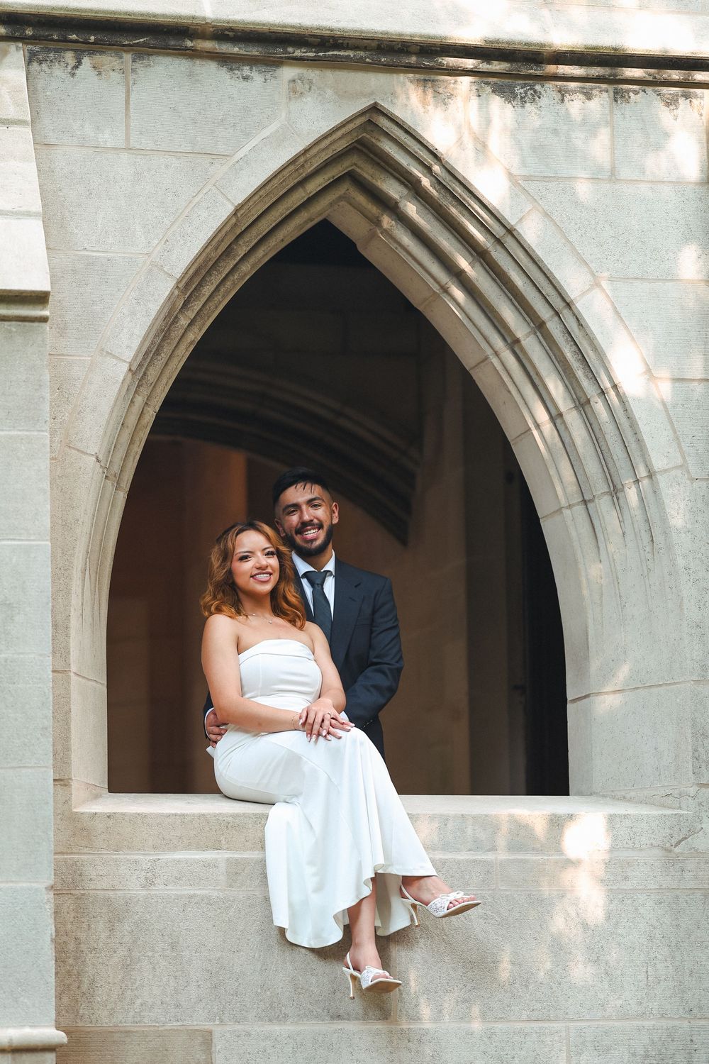 Romantic wedding photo shoot in Gothic stone archways with natural lighting.