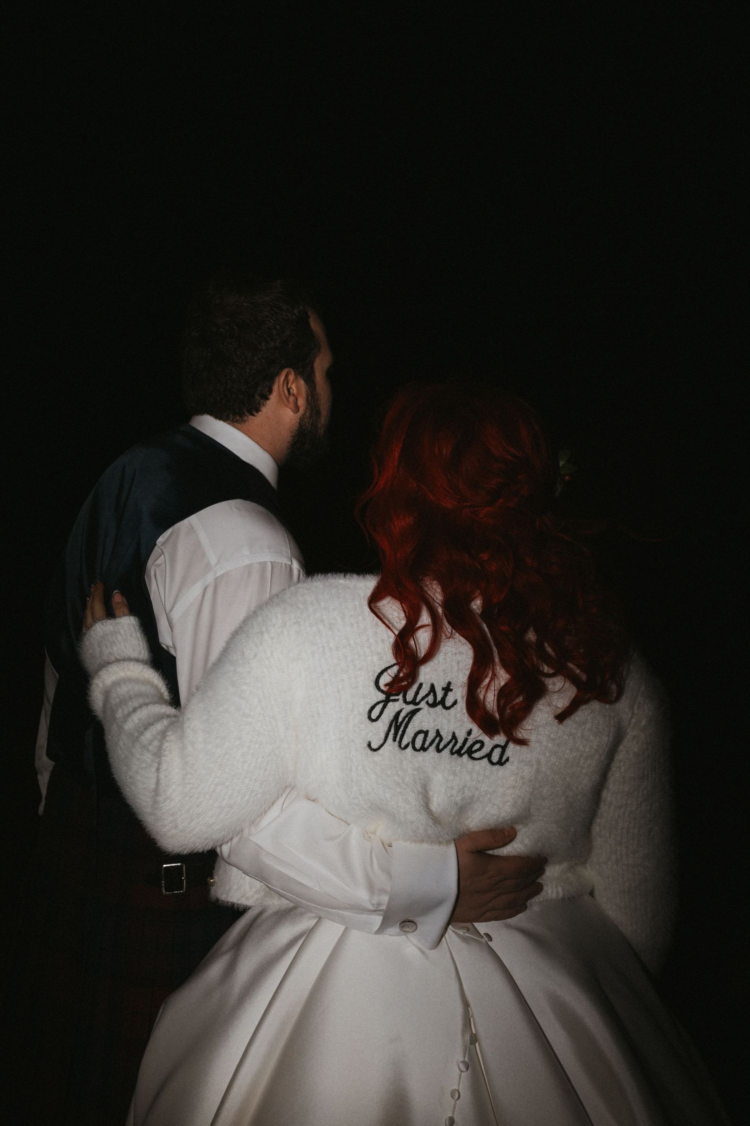 Back view of newlyweds in formal attire with 'Just Married' text visible.